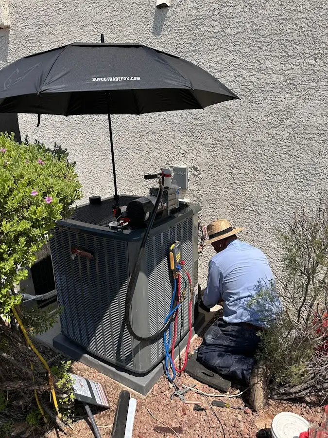 HVAC technician performing outdoor AC maintenance in Easton